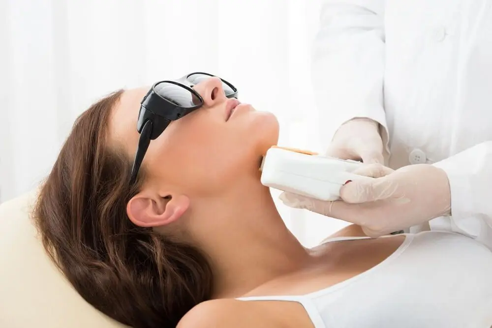 A woman getting her face waxed at the salon