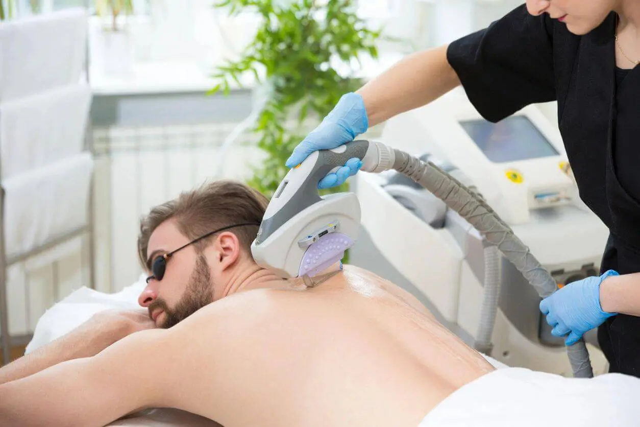 A man getting his back shaved off